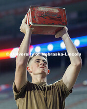 Midshipman Cedric Knudsen lifts an ammo crate into the air. Navy and Marine Corps 249th birthday cel
