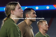 Midshipman Elianna Bryne, from left, Ensign Peyton Weigand, and Gunnery Sergeant Scott Johnson watch