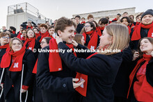 One choir member helps another adjust their scarf. Inauguration choir trip. January 17, 2025. 