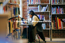 A student works on her laptop in Love Library North on the first day classes for Spring Semester 202