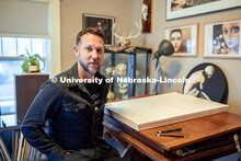 Nebraska's Scott McDonald draws at the desk in his home studio. McDonald works as a custodial manage