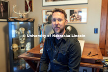 Nebraska's Scott McDonald draws at the desk in his home studio. McDonald works as a custodial manage