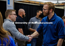 A student shakes hands with a representative from Cooper Nuclear Station at Friday’s Career Fair. 