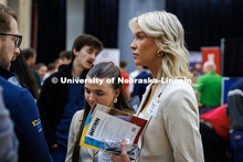Taylor Lolling, a junior Business and Law student, listens while a representative from Charles Schwa