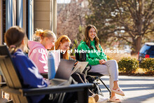 Sorority sisters of Pi Beta Phi sit in front of their house on a warm February day. February 24, 202