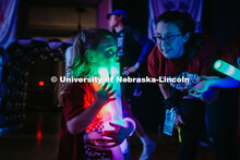 Coralie, a miracle child, holds glow sticks during the Huskerthon rave. Huskerthon 2025, also known 
