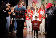 Theo, a Miracle Child, walks through the crowd with his family members during the introduction of th