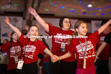 A child on Harley’s (right) pit ” and a friend raise their hands in practice for the morale danc