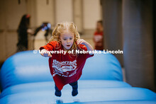Coralie, a miracle child, flies through the bounce house at the 2025 Huskerthon. Huskerthon 2025, al