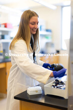 University of Nebraska–Lincoln undergraduate Avery Marquis, poses in lab coat for a photo in Luwen