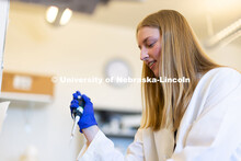 University of Nebraska–Lincoln undergraduate Avery Marquis, poses in lab coat for a photo in Luwen