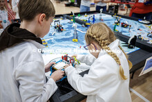 The “Mad Scientists” group tend to their robot during the practice robot match against the Irish