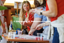 Izzy Pitre, an incoming Husker from Wisconsin, makes a friendship bracelet at the tailgate for incom