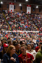 The crowd of admitted students and their families watch the Admitted Student Day presentation inside
