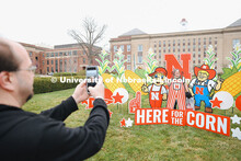 Parents take photos at the “Here for the Corn” sign-in at the Visitor Center Admitted Students D