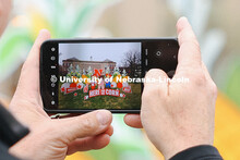 Parents take photos at the “Here for the Corn” sign-in at the Visitor Center Admitted Students D