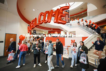 Admitted students and their parents walk under a welcoming balloon arch in the Nebraska Union and vi