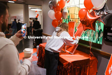 Admitted students sign signs a large “N” poster inside the Nebraska Union on Admitted Students D