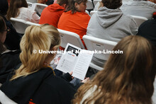 A student looks over the agenda at the Admitted Student Day event in the Coliseum. Full Coliseum on 