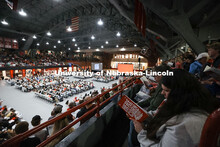 A student looks over the agenda at the Admitted Student Day event in the Coliseum. Full Coliseum on 
