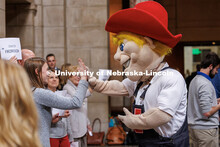 Herbie high-fives Liz Husmann of UNMC during the I Love NU Day Celebration in the Capitol’s Rotund