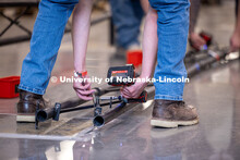 The UNL Team disassembling their bridge at the end of the ASCE Steel Bridge Competition in Kiewit Ha