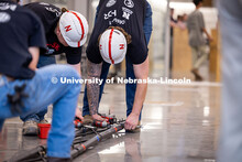 Mason Miller disassembles the UNL Team’s steel bridge at the end of the ASCE Steel Bridge Competit