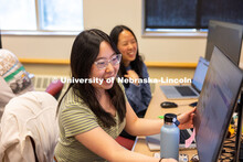 Victoria Chin shows Ealynn Hsu something on her screen as they work on their Raikes School Design St