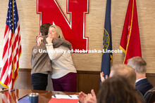 Jessie Herrmann, director of government relations, gives UNL senior Luke McDermott a congratulatory 