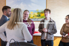 Luke McDermott (second from right), a senior at the University of Nebraska–Lincoln, converses with