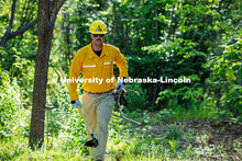 Sam Morrow, a senior Grassland Systems major, carries sticks over to cover the fireline the class cr