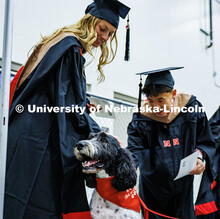 (Left) Accountancy graduate students, Mallory Schuh and Alvan Tran, pet Cash, the University Police 