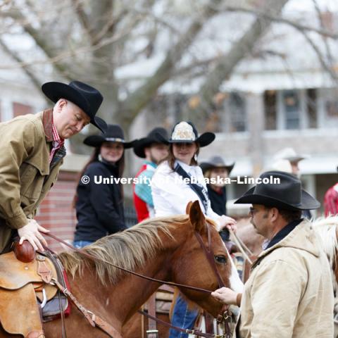 Governor Pete Ricketts throws a leg across Reuben, his ride for the proclamation. The Governor rode with the University of Nebraska-Lincoln rodeo team on the streets around the Governor's Mansion. He rode with the team to proclaim this week "rodeo Week"