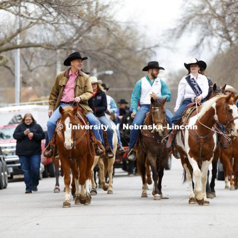 Governor Pete Ricketts talks with Jill Oatman, University of Nebraska-Lincoln Miss Rodeo, as the Governor rides with the University of Nebraska-Lincoln rodeo team on the streets around the Governor's Mansion. He rode a horse named Reuben with the team to