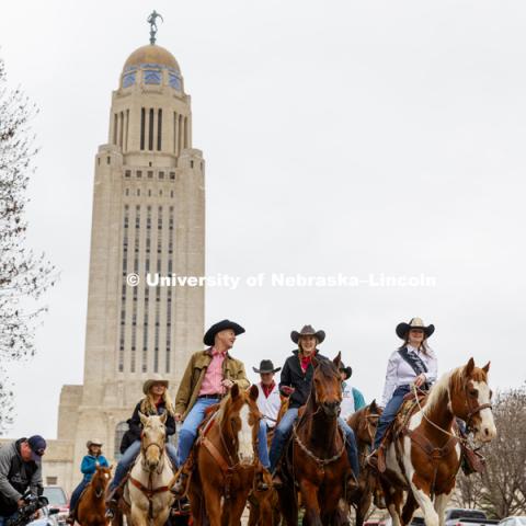 Governor Pete Ricketts rides with the University of Nebraska-Lincoln rodeo team on the streets around the Governor's Mansion. He rode a horse named Reuben with the team to proclaim this week "rodeo Week" in honor of the UNL Rodeo this weekend. April 10,