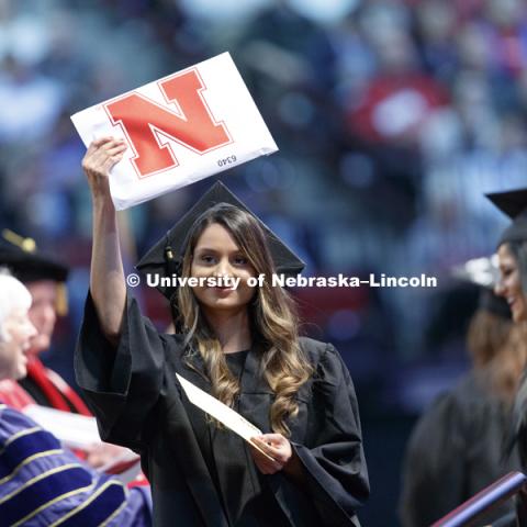 Nadia Syed shows off her College of Education and Human Sciences diploma to family and friends in the arena. Students received their undergraduate diplomas Saturday morning in Lincoln's Pinnacle Bank Arena. 2452 degrees were awarded Saturday morning. May