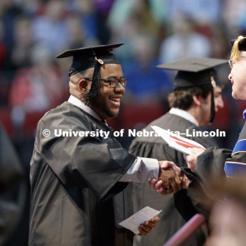 Marvin Cunningham receives his engineering degree Saturday morning. Students received their undergraduate diplomas Saturday morning in Lincoln's Pinnacle Bank Arena. 2452 degrees were awarded Saturday morning. May 6, 2017. Photo by Craig Chandler /