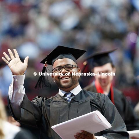 Marvin Cunningham waves to family and friends in the arena after receiving his Engineering diploma. Students received their undergraduate diplomas Saturday morning in Lincoln's Pinnacle Bank Arena. 2452 degrees were awarded Saturday morning. May 6, 2017.