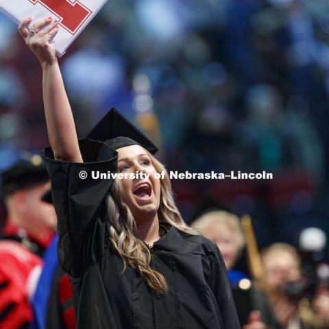 Paige Duin shows off her College Business diploma to family and friends in the arena. Students received their undergraduate diplomas Saturday morning in Lincoln's Pinnacle Bank Arena. 2452 degrees were awarded Saturday morning. May 6, 2017. Photo by Craig
