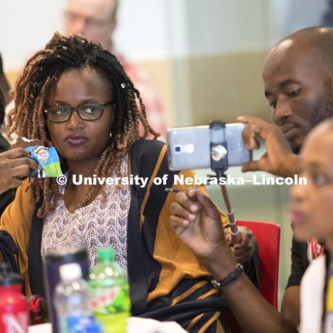 Obolibe from Togo films Fatou from Guinea sample a Ben and Jerry's ice cream slice while listening to Chris Tuggle, Assistant Professor of Marketing, talk about strategic management using the icre cream company as an example. Mandela Washington Fellowship