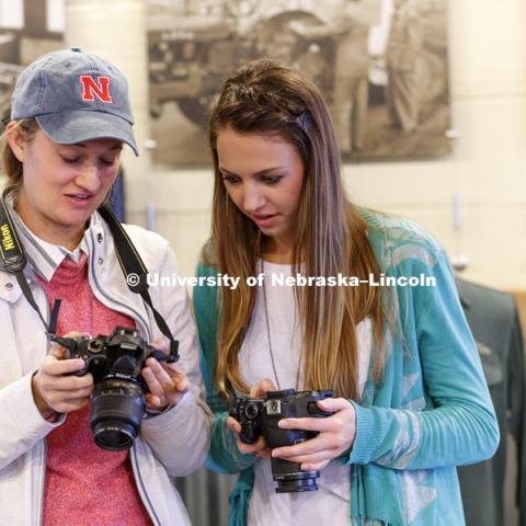 Natalie Jones and Erika Harms review their photos. Students in Jamie Loizzo's ALEC 240 - Digital Photography and Visual Communication for Agriculture and the Environment practice their photography during a field trip to the Larsen Tractor Test Museum.