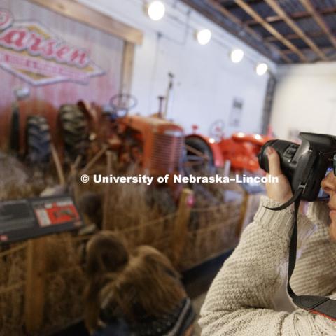 Megan Engel photographs the museum's centerpiece display. Students in Jamie Loizzo's ALEC 240 - Digital Photography and Visual Communication for Agriculture and the Environment practice their photography during a field trip to the Larsen Tractor Test