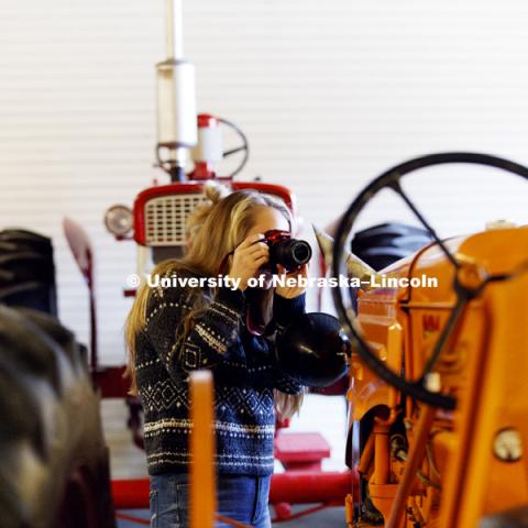 Students in Jamie Loizzo's ALEC 240 - Digital Photography and Visual Communication for Agriculture and the Environment practice their photography during a field trip to the Larsen Tractor Test Museum. November 8, 2017. Photo by Craig Chandler / University