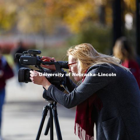 Nela Krawiecova, works on her digital media assignment as she films along R Street. November 15, 2017. Photo by Craig Chandler / University Communication.