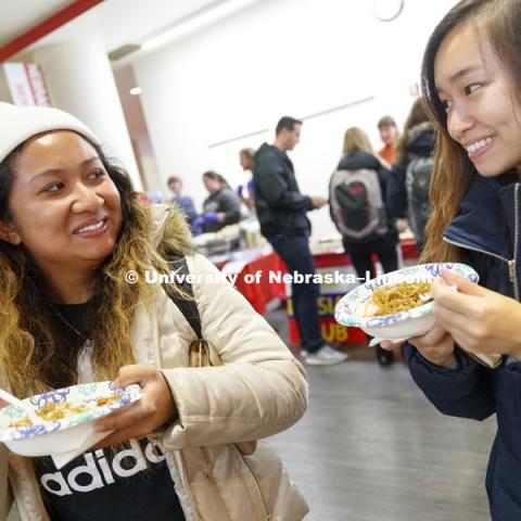 Shannon Pham and Connie Nguyen compare dishes at the International Food Bazaar. The International Food Bazaar showcases cuisines from all over the world. Registered student organizations representing a variety of countries and cultures will prepare and
