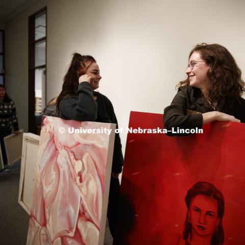 Lindsey Pinkerton, right, and Abby Birkel chat while waiting to check in their submissions to be judged for an undergraduate art show in Richards Hall. January 31, 2018. Photo by Craig Chandler / University Communication.