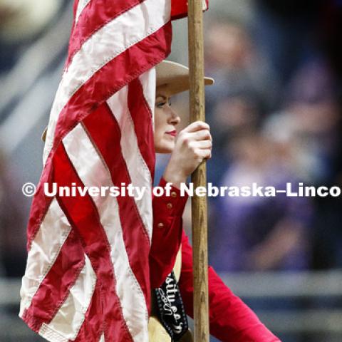 Miss Rodeo University of Nebraska-Lincoln Shelby Riggs brings in the American flag to begin the rodeo. 60th anniversary of the University of Nebraska-Lincoln Rodeo Club. April 20, 2018. Photo by Craig Chandler / University Communication.