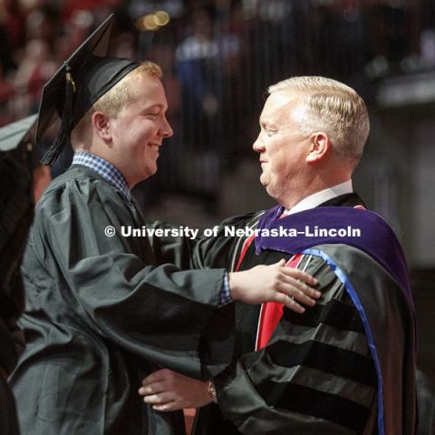 Daniel Clare receives his business diploma from his dad, Nebraska Regent Tim Clare. Undergraduate Commencement at Pinnacle Bank Arena. May 5, 2018. Photo by Craig Chandler / University Communication.
