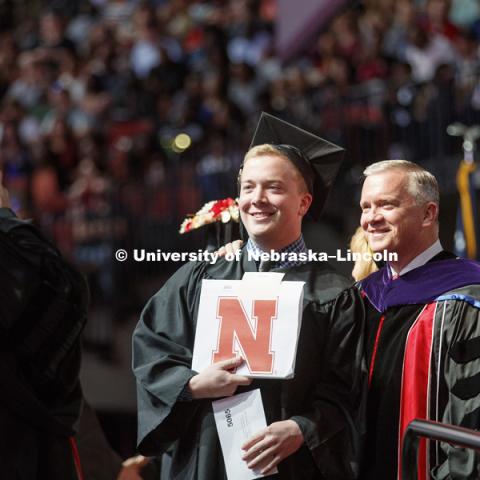 Daniel Clare poses for a photo after receiving his business diploma from his dad, Nebraska Regent Tim Clare. Undergraduate Commencement at Pinnacle Bank Arena. May 5, 2018. Photo by Craig Chandler / University Communication.
