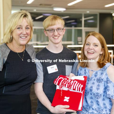 Sam Harvey, center, is surrounded by Executive Vice Chancellor Donde Plowman, left, and his mom, Elisia Flaherty. Sam is a high school junior from Grand Island and scored a perfect ACT score. June 19, 2018. Photo by Craig Chandler / University